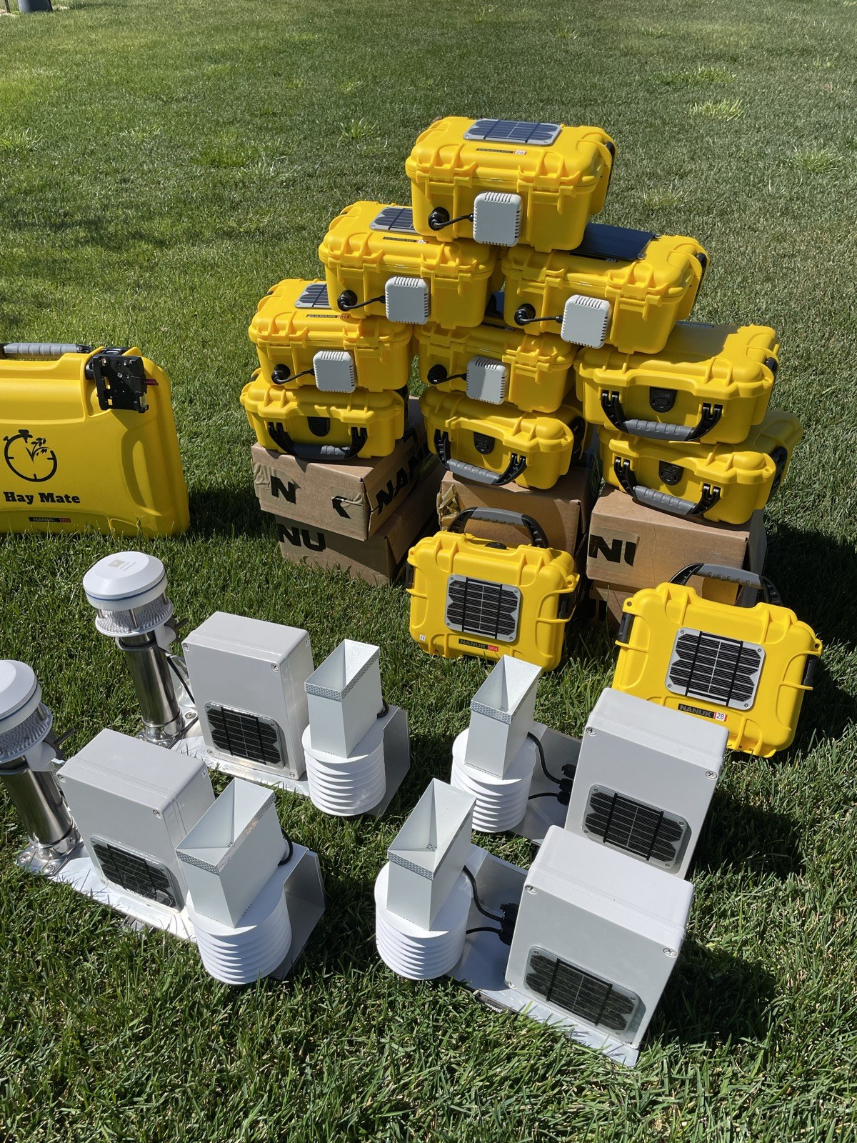 Current HayMate units with solar top-up panels and monitoring equipment displayed outdoors